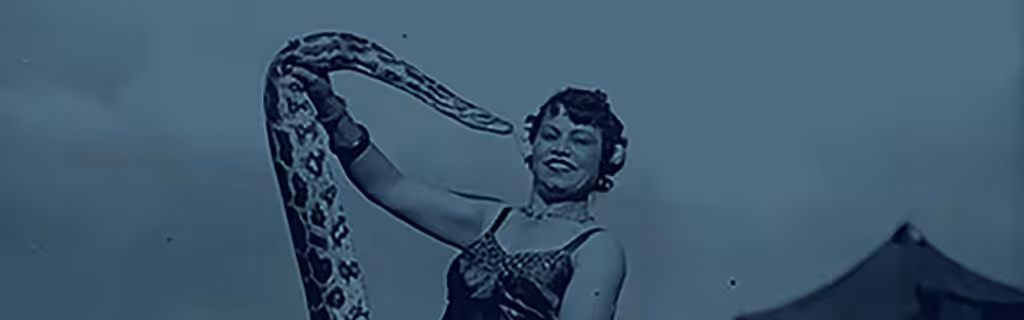 Image of circus worker holding a snake