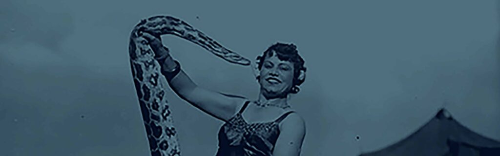 Image of circus worker holding a snake
